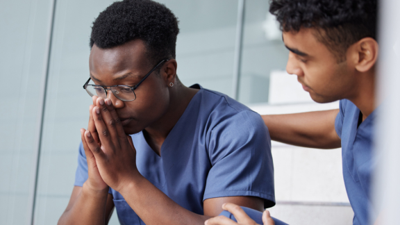Doctor sat with head in hands