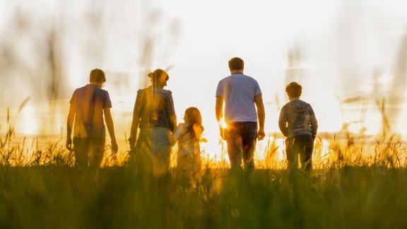 Family walking in field