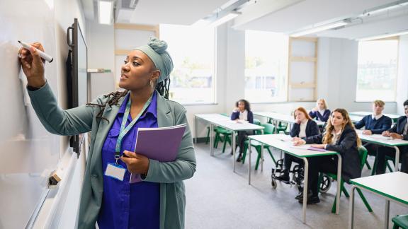 Teacher teaching school students
