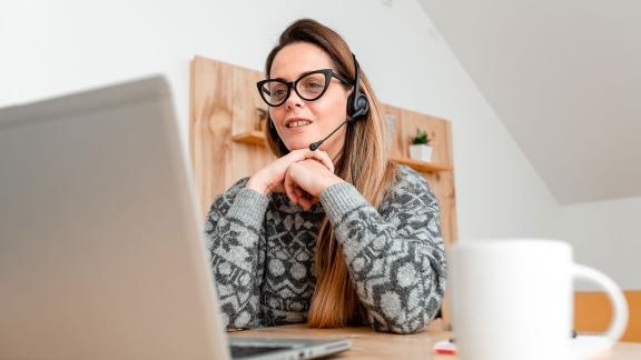 Homeworker wearing headset, video call