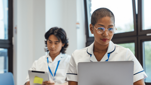 One nurse wearing glasses