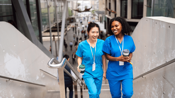 Two nurses climbing the staircase