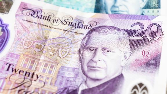 Five pound note and twenty pound note fanned with King Charles' head displaying and 'Bank of England'