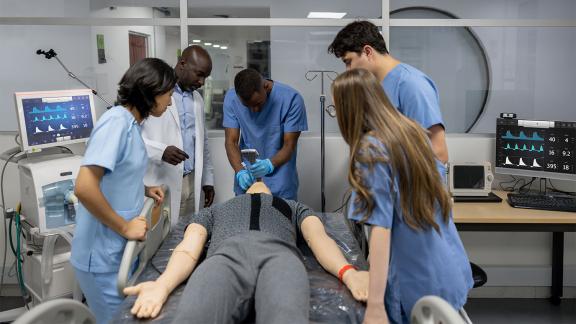 Medical students practicing on a dummy