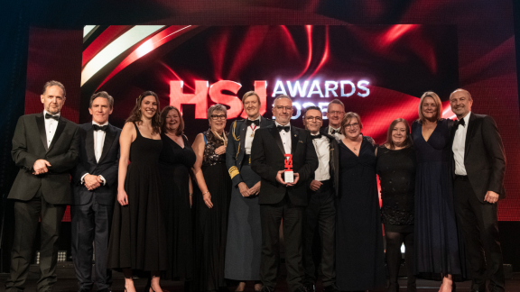 The team from ESHT receive their HSJ award from Rob Brydon