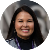 Louie Horne is Filipino, she has long black straight hair and is smiling