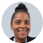 Headshot of Maureen who is of ethnic minority, with dark hair tied in a bun