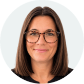 A headshot of Donna Griffiths who has brown bobbed hair and wears glasses