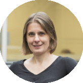 Head-and-shoulders portrait of Dr Magda Zasada with shoulder-length hair wearing a dark top