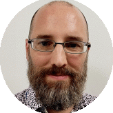 Head-and-shoulders portrait of Matt Hall wearing glasses, a full beard and patterned shirt.