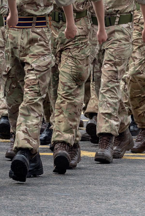 A close up of the legs of marching soldiers.