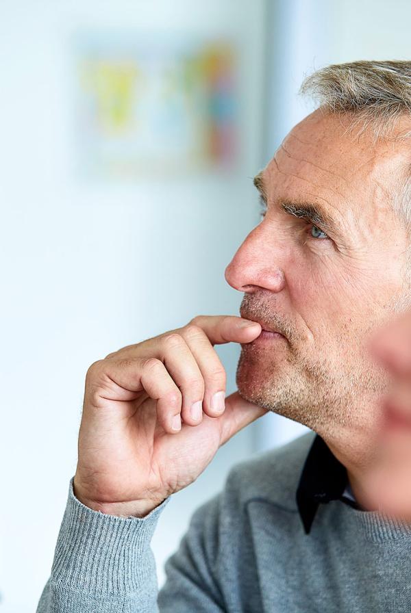 An officer worker listening in a meeting.