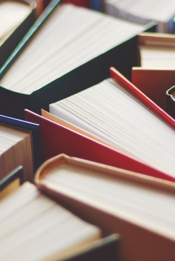 A collection of books standing on end, tessellated.