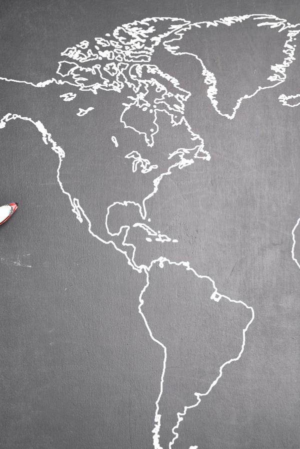 Toy plane on a black and white world map
