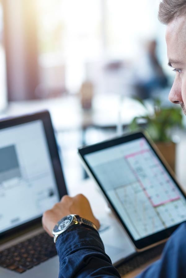 An office worker using multiple screens.