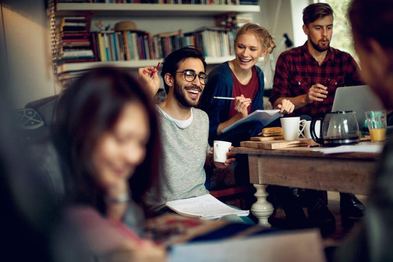 A group of students, studying and laughing.