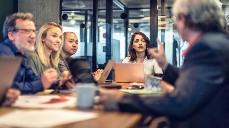 A diverse group of colleagues holding an intense meeting.