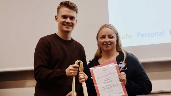 A young person receiving their certificate for their work in the Princes' Trust.